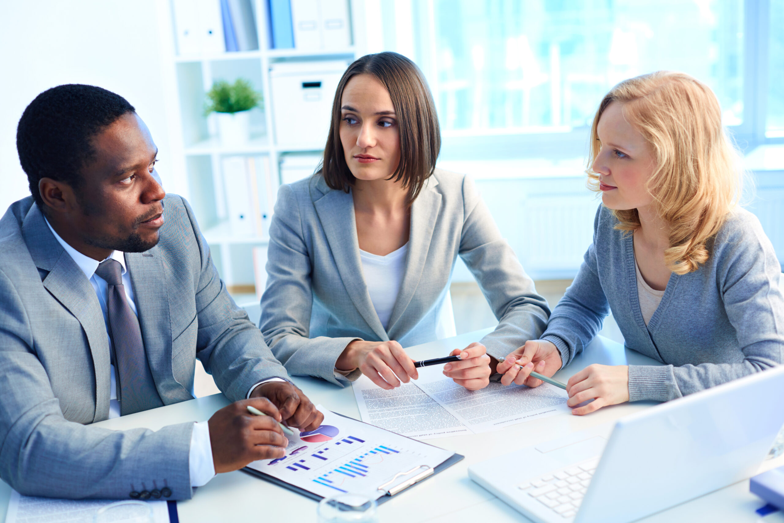 Group of serious businesspeople interacting at meeting